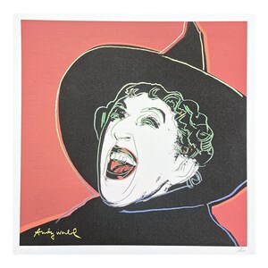 May include: Pop art print featuring a woman with a wide open mouth, wearing a black hat and coat, set against a coral background. The artwork is signed "Andy Warhol" in gold. The woman's face is white with green and red accents.