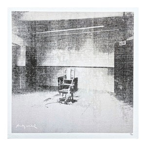 May include: Black and white photograph of an electric chair in a room with a single light fixture and a door labeled "SOLITARY". The image is signed "Andy Warhol" in the bottom left corner.