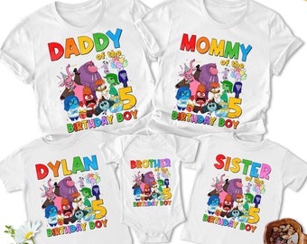May include: Five white t-shirts with a graphic of characters from the movie Inside Out. The shirts say "Daddy of the 5 Birthday Boy", "Mommy of the 5 Birthday Boy", "Dylan 5 Birthday Boy", "Brother of the 5 Birthday Boy", and "Sister of the 5 Birthday Boy".