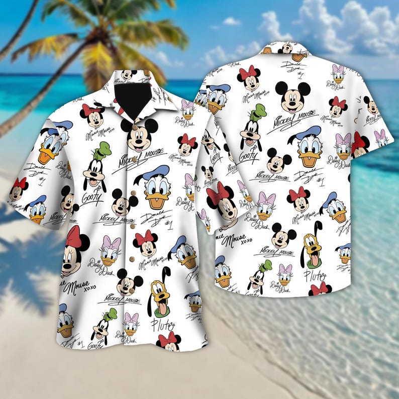 May include: White button-up shirt with a short sleeve featuring a repeating pattern of Mickey Mouse, Minnie Mouse, Donald Duck, Goofy, and Pluto characters. The characters are in colour and have their names written in black cursive.