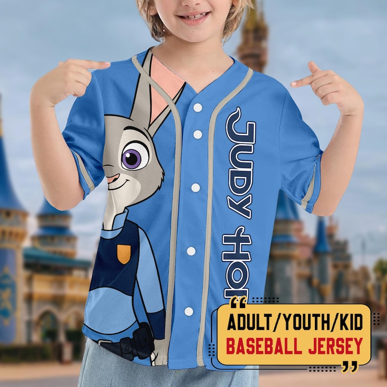 May include: A light blue baseball jersey featuring Judy Hopps from Zootopia. The jersey has a button-up front, grey trim, and the text "JUDY HOPPS" vertically down the right side. The jersey also has the text "ADULT/YOUTH/KID BASEBALL JERSEY".