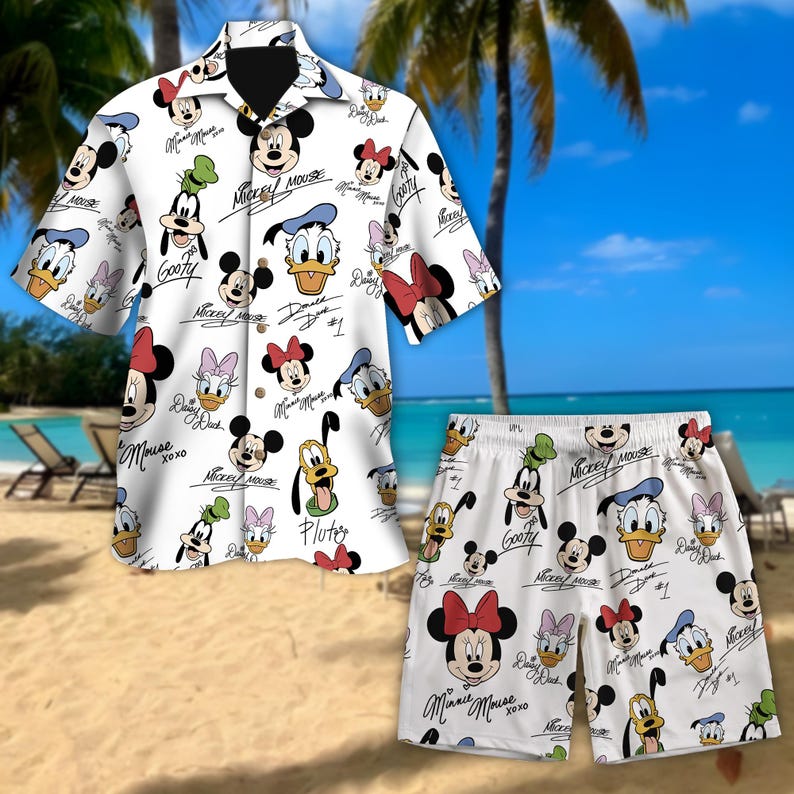 May include: White button-up shirt and matching shorts featuring a pattern of various Disney characters, including Mickey Mouse, Minnie Mouse, Donald Duck, Goofy, and Pluto. The characters are depicted in a cartoon style with their signature names and autographs.