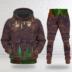 May include: A brown hoodie and matching trousers set with a tribal design. The hoodie features a hood, front pockets, and a decorative rope detail. The trousers have a leaf design at the top. The set is made of a soft, comfortable material.