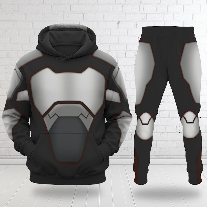 May include: A black hoodie and matching pants set with a futuristic design. The hoodie and pants feature a silver and gray panel design with red trim. The hoodie has a front pocket and a hood. The pants have a matching design.