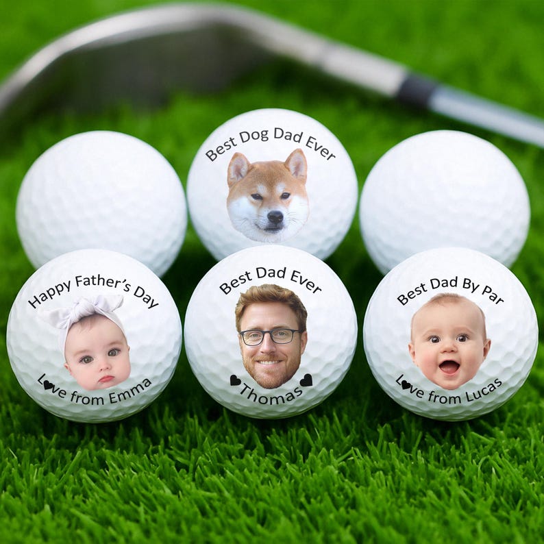 May include: White golf balls with personalized images and text. One ball features a Shiba Inu dog with "Best Dog Dad Ever." Other balls have baby and adult faces with text like "Happy Father's Day" and "Best Dad Ever."