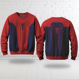 A red and blue Spiderman-themed sweater is displayed against a white brick wall.