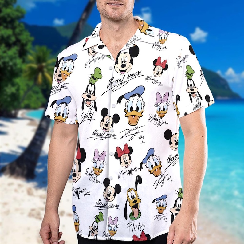 May include: White short-sleeved button-down shirt with a colourful all-over print of Mickey Mouse, Minnie Mouse, Donald Duck, Daisy Duck, Goofy, and Pluto. Each character has their signature underneath their image.