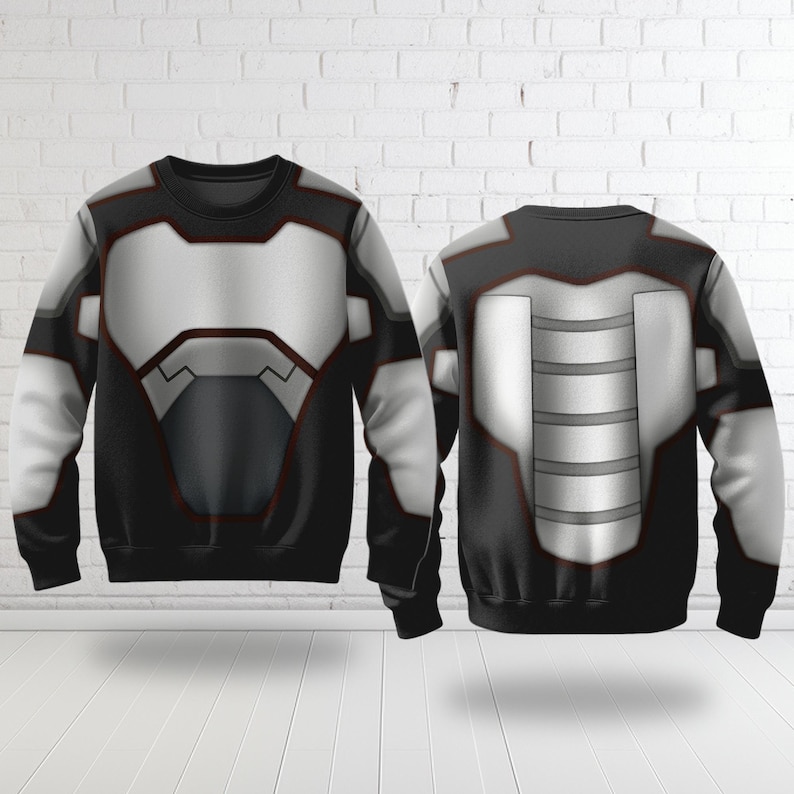 May include: A black sweatshirt with a futuristic design, featuring a white and gray chest plate and accents. The back of the sweatshirt also displays a similar design. The overall aesthetic is reminiscent of a superhero or sci-fi theme.