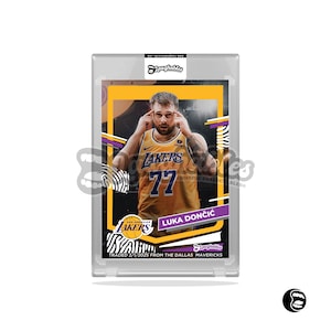 May include: A basketball trading card featuring Luka Dončić wearing a yellow and purple Los Angeles Lakers jersey with the number 77 on the front. The card has a black and white zebra print background with a yellow border. The text on the card reads "Luka Dončić" and "Traded 2/1/2023 from the Dallas Mavericks".