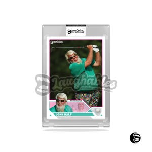 May include: A trading card featuring golfer John Daly in a green shirt and sunglasses mid-swing. The card has a white border with the Laughables logo and text. The bottom of the card reads "JOHN DALY PRO GOLFER".