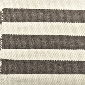 May include: A white and brown striped woven rug with a textured surface.
