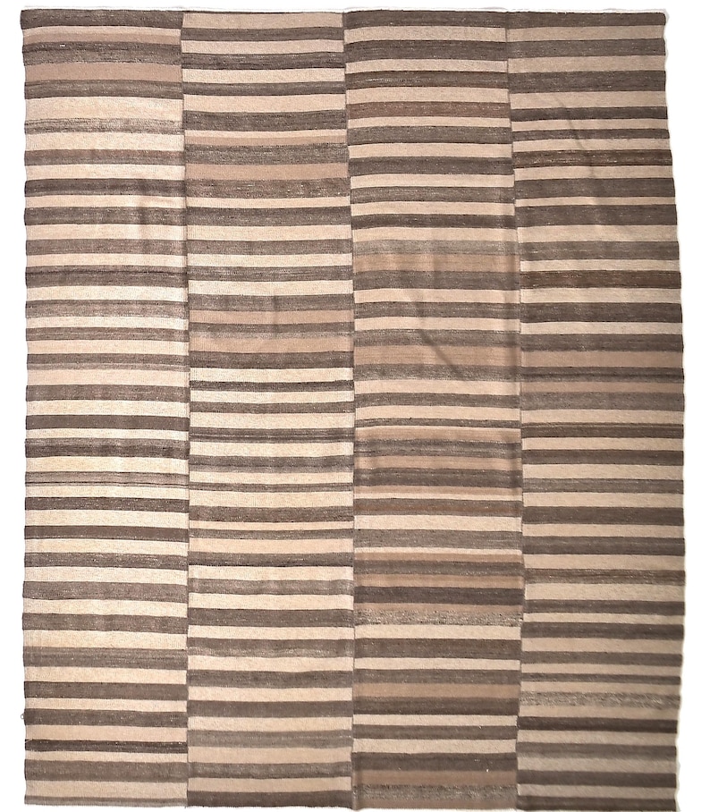 May include: A striped rug with a beige and brown colour scheme. The rug is made of woven fabric and has a rectangular shape.