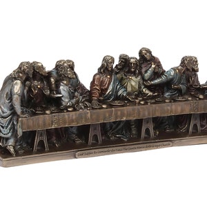 May include: A bronze sculpture depicting Leonardo da Vinci's The Last Supper, featuring 13 figures seated around a table. The sculpture is a detailed replica of the famous fresco in the Santa Maria delle Grazie church in Milan, Italy.