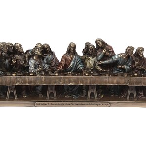 May include: A bronze sculpture depicting Leonardo da Vinci's The Last Supper. The sculpture shows Jesus and his 12 disciples seated around a table, with Jesus in the center. The sculpture is detailed and realistic, with each figure having a unique expression and pose. The sculpture is mounted on a base with the inscription "Last Supper by Leonardo da Vinci The Santa Maria delle Grazie Church".