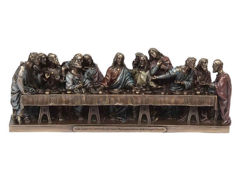 May include: A bronze sculpture depicting Leonardo da Vinci's The Last Supper. The sculpture shows Jesus and his 12 disciples seated around a table, with Jesus in the center. The sculpture is detailed and realistic, with each figure having a unique expression and pose. The sculpture is mounted on a base with the inscription "Last Supper by Leonardo da Vinci The Santa Maria delle Grazie Church".
