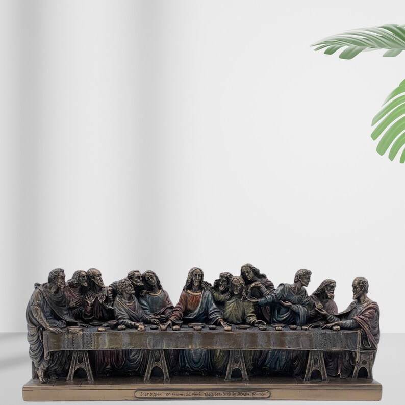 May include: A bronze sculpture depicting the Last Supper, featuring 13 figures seated around a table. The sculpture is detailed with intricate carvings and a realistic depiction of the figures' expressions. The sculpture is mounted on a wooden base with the inscription "Last Supper - Brienzo, Italy - The S. Marialla Bronze Works - Bordi"