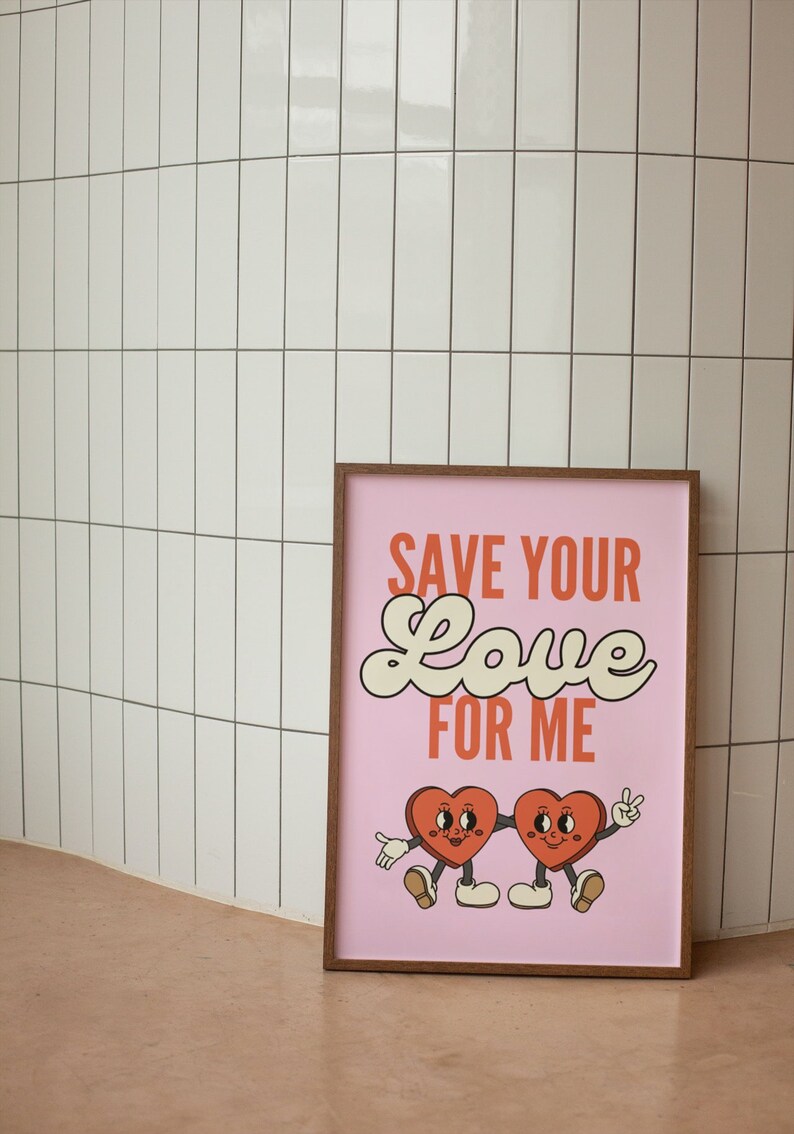 May include: A pink framed print with the text "SAVE YOUR LOVE FOR ME" in white and orange lettering. Two cartoon hearts with legs and faces are holding hands.