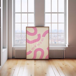 May include: A beige and pink abstract art print with the text "PULL ME OUT OF THIS" in pink. The print features pink curved lines on a beige background.