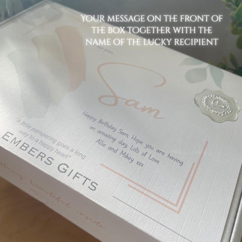 May include: A gift box with a personalized message for "Sam" in elegant script. The box is white with a textured finish and features a decorative wax seal and the text "EMBERS GIFTS". The box includes a message wishing Sam a happy birthday.