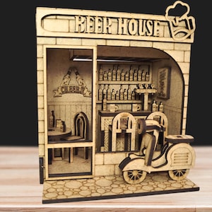May include: A wooden miniature of a beer house with the text "BEER HOUSE" above the entrance. The interior features a bar, shelves of bottles, and a scooter. The word "CHEERS" is visible on a banner.