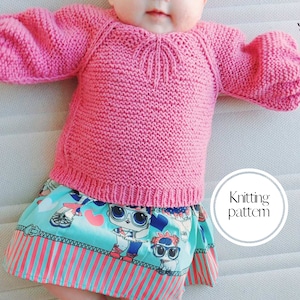 May include: A pink knitted baby sweater with a cable knit pattern and a round neckline. The sweater is being worn by a baby, and the image includes the text "Knitting pattern".