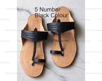 May include: Pair of black leather sandals with a toe loop and strap design. The sandals have a light brown sole and the text "5 Number Black Colour" is visible.