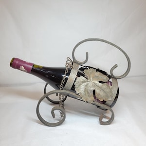 Vintage tabletop or hanging metal wine bottle holder.