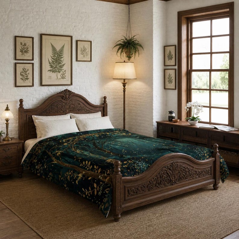 May include: A dark teal and gold comforter on a carved wooden bed frame. The comforter features a forest design with gold accents. The bedroom has a neutral color palette with framed botanical prints and a hanging plant.