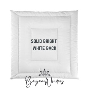 May include: A white comforter with a quilted design. The text "SOLID BRIGHT WHITE BACK" is printed in the center. The Bazaar Wonders logo is at the bottom.