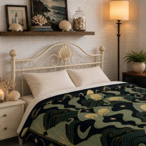 May include: A bed with a cream-colored metal headboard and a comforter featuring a dark blue, green, and gold seashell and wave pattern. The room is decorated with coastal-themed decor, including a shelf with artwork and seashells.