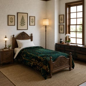 May include: A bedroom scene featuring a wooden bed with an intricately carved headboard and footboard. The bed is covered with a dark green and gold patterned blanket. The room includes a bedside table, a floor lamp, and framed botanical prints.