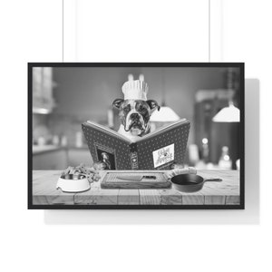 May include: A black and white photo of a dog wearing a chef's hat and reading a cookbook titled "Woof Appetit". The dog is sitting at a table with a bowl, dog biscuits, a cutting board, a knife, and a frying pan.