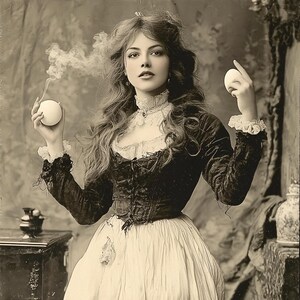 May include: A woman in a vintage dress with a lace collar and a velvet bodice holds two white orbs in her hands. She is standing in front of a backdrop with a vintage aesthetic.