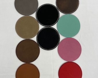 May include: Ten round leather coasters in various colors, including gray, brown, black, teal, pink, red, and orange. The coasters have a stitched edge.