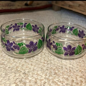 May include: A set of three ceramic mugs with a speckled, matte finish. The mugs are in shades of cream, light gray, and dark gray. Each mug has a simple, minimalist design, perfect for coffee or tea.