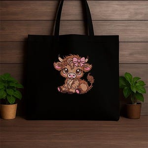 May include: Black tote bag with an embroidered Highland cow design. The cow is brown with a pink bow, large eyes, and pink details. The bag has black handles and is made of a durable material. The design is a charming illustration.