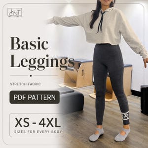 May include: A PDF pattern for basic leggings in sizes XS to 4XL, featuring stretch fabric. The image displays dark gray leggings with a white logo on the lower leg, paired with a light gray cropped hoodie and light gray ballet-style slippers.