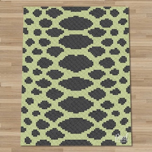 May include: A green and gray rug with a repeating pattern of black ovals on a light green background. The rug has a pixelated look.