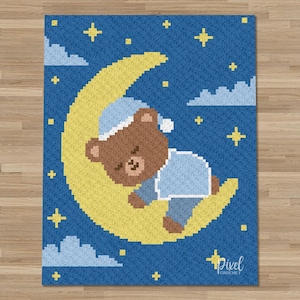 May include: A pixel art design featuring a brown bear in a blue nightcap and pajamas, sleeping on a yellow crescent moon. The background is a dark blue sky with white clouds and yellow stars. The word "Pixel Crochet" is in the bottom right corner.