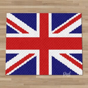 May include: A rectangular rug displaying the Union Jack, the flag of the United Kingdom. The design uses red, white, and blue, with a central red cross and diagonal white and red stripes on a blue field. The rug is placed on a wooden floor.