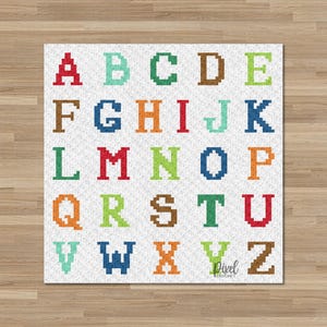 May include: A colorful alphabet design featuring the letters A through Z in various colors. The letters are in a pixelated style, with each letter a different color, including red, blue, green, and orange. The background is white with a subtle texture.