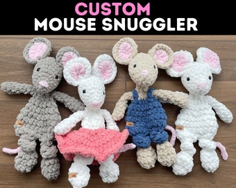 May include: Four crocheted mouse plushies in different colors and outfits. The gray mouse has a pink nose and tail. The white mouse has a pink nose and tail and is wearing a pink skirt. The beige mouse has a pink nose and tail and is wearing blue overalls. The white mouse has a pink nose and tail.