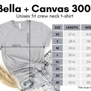 May include: A gray Bella + Canvas 3001 unisex crew neck t-shirt with size chart showing measurements in inches. The chart includes sizes XS, S, M, L, XL, 2X, 3X, and 4X. The t-shirt is laid flat on a white surface.