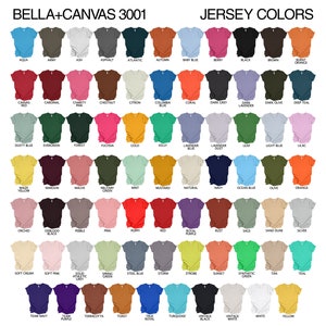 May include: A color chart of Bella+Canvas 3001 jersey t-shirts, showcasing a wide array of colors. The chart includes shades like Aqua, Army, Ash, Asphalt, Atlantic, Autumn, and Baby Blue, among others. The text "JERSEY COLORS" is displayed at the top.