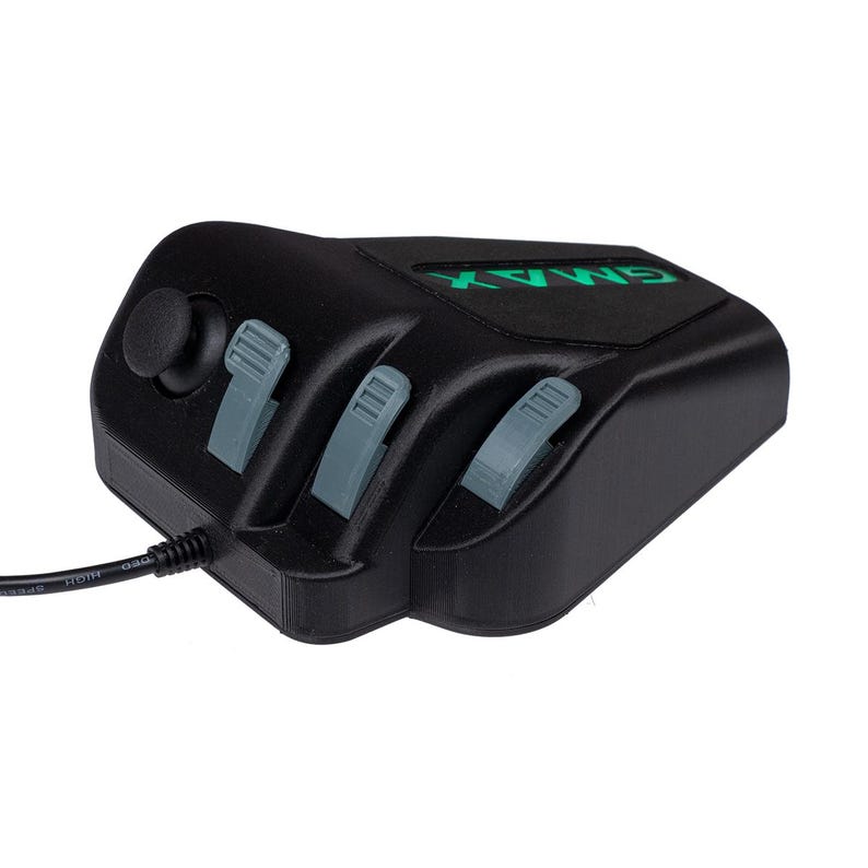 May include: A black gaming controller with three gray slider buttons and a green joystick. The controller has the word "GAMAX" printed on it in green.
