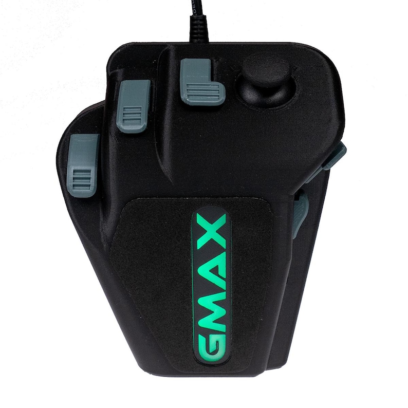 May include: A black gaming mouse with a green GMAX logo and four gray buttons. The mouse has a textured surface and a round button on the top.