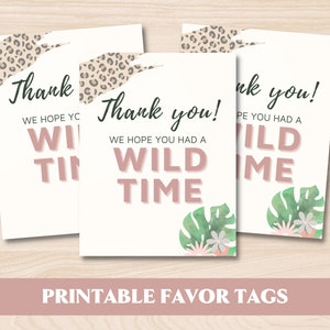 May include: Three printable favor tags with a jungle theme. The tags are white with pink text that says "Thank you! We hope you had a wild time."  The tags are decorated with a leopard print, green leaves, and pink flowers.
