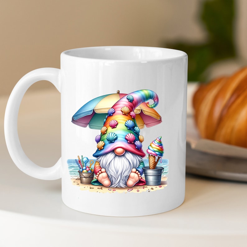 May include: White ceramic coffee mug featuring a colourful gnome illustration. The gnome is wearing a rainbow hat with seashells and holding an ice cream cone. The gnome is sitting on a beach under a colourful umbrella.