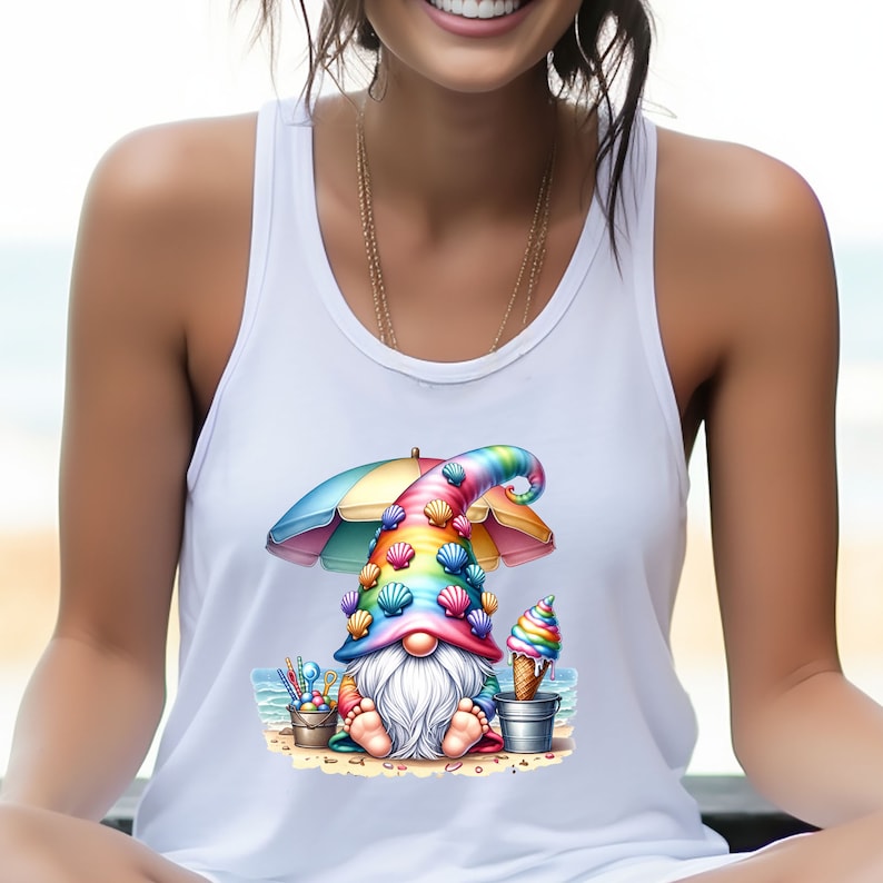 May include: A white tank top featuring a colourful gnome wearing a rainbow hat adorned with seashells and holding an ice cream cone. The gnome is seated on a beach beneath a beach umbrella.