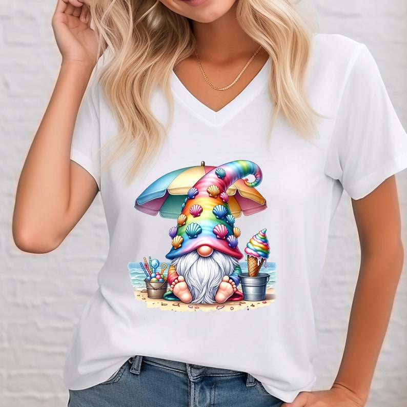 May include: A white t-shirt featuring a colourful gnome wearing a seashell hat and holding an ice cream cone. The gnome is sitting on a beach under a rainbow umbrella.